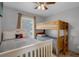 Bright bedroom featuring a full bed and a bunk bed, offering comfortable sleeping arrangements at 166 Paradise Island Dr, Haines City, FL 33844