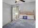Cozy bedroom with a decorative headboard, ceiling fan and a window that lets in plenty of natural light at 166 Paradise Island Dr, Haines City, FL 33844