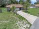 Well-kept single Gathering home with a long driveway, mature landscaping, and lawn at 166 Paradise Island Dr, Haines City, FL 33844