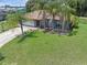 Well-maintained home with a two-car garage, lush lawn, mature palm trees, and enhanced curb appeal at 166 Paradise Island Dr, Haines City, FL 33844