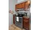 Kitchen featuring stainless steel oven and matching wooden cabinets and granite countertops at 166 Paradise Island Dr, Haines City, FL 33844
