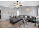 Open living room with a gray sectional sofa and glass-top coffee table, perfect for relaxation at 166 Paradise Island Dr, Haines City, FL 33844