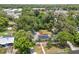 An aerial view of a well-maintained home surrounded by lush trees and landscaping at 1800 Banyan St, Orange City, FL 32763