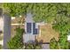 This is an aerial view of the house with solar panels, a driveway and surrounding trees at 1800 Banyan St, Orange City, FL 32763