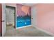 bedroom with neutral carpet and custom mural on one wall at 1800 Banyan St, Orange City, FL 32763