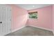 Small bedroom with a neutral carpet and a window at 1800 Banyan St, Orange City, FL 32763