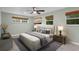 Cozy bedroom with stylish decor, large windows, and a ceiling fan at 1800 Banyan St, Orange City, FL 32763
