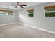 Empty bedroom with neutral walls, carpeted floor, and natural light from three windows at 1800 Banyan St, Orange City, FL 32763