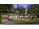 Charming single story home with a well manicured lawn and mature landscaping around the property at 1800 Banyan St, Orange City, FL 32763