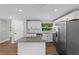 Modern kitchen features white cabinets, granite counters, stainless steel appliances and wood flooring at 1800 Banyan St, Orange City, FL 32763