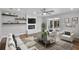 Modern living room with a decorative fireplace, sliding glass doors and stylish furnishings at 1800 Banyan St, Orange City, FL 32763