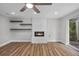 Open living room with hardwood floors, modern fireplace, and access to the backyard at 1800 Banyan St, Orange City, FL 32763