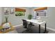 This is a home office featuring a desk with computer, artwork, a plant and a window at 1800 Banyan St, Orange City, FL 32763