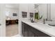 Bathroom featuring double sinks, white countertops, and dark wood cabinets at 1845 Island Village Way, Celebration, FL 34747