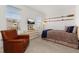 Bedroom with leather chair, brown bedding, and decorative oars on the wall at 1845 Island Village Way, Celebration, FL 34747