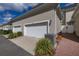 Exterior view of home featuring two garage doors and a brick walkway at 1845 Island Village Way, Celebration, FL 34747