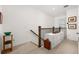 Upstairs hallway with carpet, wood railings, and built-in filing cabinet at 1845 Island Village Way, Celebration, FL 34747
