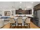 Open kitchen design with central island, pendant lighting, and stainless steel appliances at 1845 Island Village Way, Celebration, FL 34747