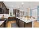 Bright kitchen with stainless steel appliances, island with seating, and modern finishes at 1845 Island Village Way, Celebration, FL 34747