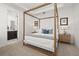 Stylish primary bedroom with a four poster bed, recessed lights and ensuite bathroom at 1845 Island Village Way, Celebration, FL 34747