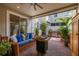 Inviting outdoor patio with comfortable wicker furniture, a ceiling fan, and lush greenery at 1845 Island Village Way, Celebration, FL 34747