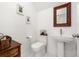 Powder room with pedestal sink, toilet, and neutral walls at 1845 Island Village Way, Celebration, FL 34747