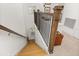 Elegant staircase with wooden steps, a wrought iron railing, and natural light at 1845 Island Village Way, Celebration, FL 34747