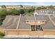 Aerial view shows a tan townhome with brown garage doors and a fenced-in patio at 2050 Island Walk Dr, Orlando, FL 32824