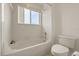 This clean bathroom features a window over the tub and shower and a white toilet at 2050 Island Walk Dr, Orlando, FL 32824