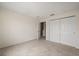 Bedroom featuring a closet, bathroom access, neutral walls, and carpeted floors at 2050 Island Walk Dr, Orlando, FL 32824