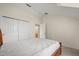 Bedroom featuring a closet and bathroom access, neutral walls, and carpeted floors at 2050 Island Walk Dr, Orlando, FL 32824