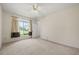 Bedroom featuring a large window, neutral walls, and carpeted floors, with open doorway to the bathroom at 2050 Island Walk Dr, Orlando, FL 32824