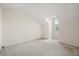 A large bedroom with an angled window has neutral carpeting at 2050 Island Walk Dr, Orlando, FL 32824