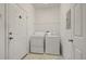 Practical laundry room with a washer, dryer, and storage shelf at 2050 Island Walk Dr, Orlando, FL 32824