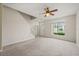 Bright living room with a ceiling fan and large window for natural light at 2050 Island Walk Dr, Orlando, FL 32824