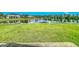 Lush green backyard extending to a tranquil pond, perfect for relaxation and outdoor enjoyment at 2054 Hammock Moss Dr, Orlando, FL 32820