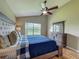 Comfortable bedroom featuring a ceiling fan, lake view, and wooden dresser at 2054 Hammock Moss Dr, Orlando, FL 32820