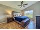 Spacious bedroom with a large window overlooking a serene landscape and a ceiling fan at 2054 Hammock Moss Dr, Orlando, FL 32820