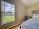 Bedroom showcasing lake view from window with neutral walls and wood floors at 2054 Hammock Moss Dr, Orlando, FL 32820