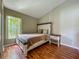 Bedroom with a window featuring blinds, wood floors, neutral walls, and queen bed at 2054 Hammock Moss Dr, Orlando, FL 32820