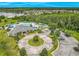Aerial view of community pool, clubhouse, lake with fountain, and playground with mature trees at 2054 Hammock Moss Dr, Orlando, FL 32820