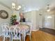 Charming dining room with hardwood floors, chandelier, and inviting atmosphere adjacent to kitchen at 2054 Hammock Moss Dr, Orlando, FL 32820