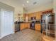 Modern kitchen with stainless steel appliances, wooden cabinetry, and granite countertops at 2054 Hammock Moss Dr, Orlando, FL 32820