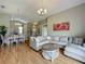 Spacious living room with hardwood floors, neutral tones, vaulted ceiling, and formal dining area at 2054 Hammock Moss Dr, Orlando, FL 32820