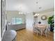 Bright and airy living room features a vaulted ceiling, wood floors, and dining area at 2054 Hammock Moss Dr, Orlando, FL 32820
