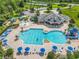Aerial view of community pool featuring a splash pad, playground, lounge chairs, and a slide at 2054 Hammock Moss Dr, Orlando, FL 32820