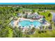 Aerial view of community pool featuring a splash pad, playground, lounge chairs, and a slide at 2054 Hammock Moss Dr, Orlando, FL 32820