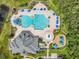 Aerial view of community pool featuring a splash pad, playground, lounge chairs, and a slide at 2054 Hammock Moss Dr, Orlando, FL 32820