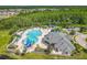 Aerial view of community pool featuring a splash pad, playground, lounge chairs, and a slide at 2054 Hammock Moss Dr, Orlando, FL 32820
