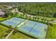 Aerial view of community tennis courts with lush landscaping and mature shade trees at 2054 Hammock Moss Dr, Orlando, FL 32820